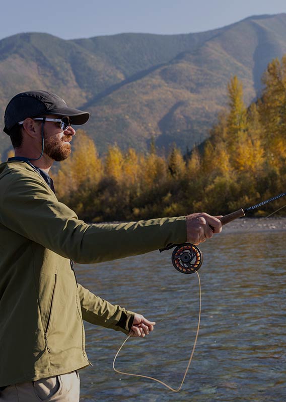 Profile of a man casting off a fishing line with sunlight hitting his chest