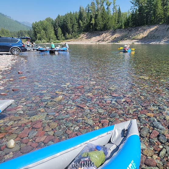 View from a kayak at a river bed with others setting up their boats