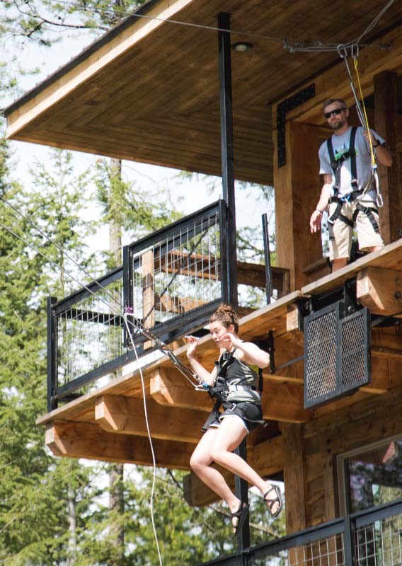 A person attached with a swing jumps from a platform.