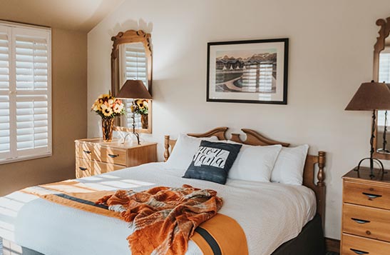 Guest room at Grouse Mountain Lodge with sunlight shining on a bed.