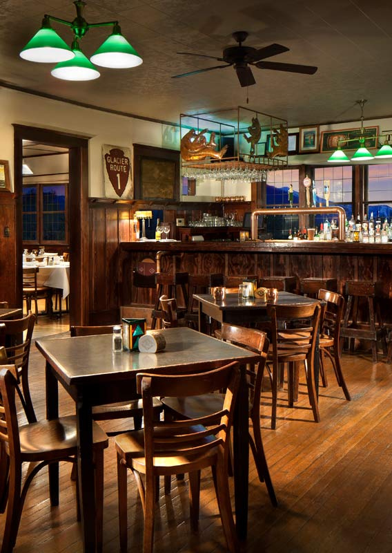 The Belton Chalet Tap Room with wooden interior detailing, tables and chairs