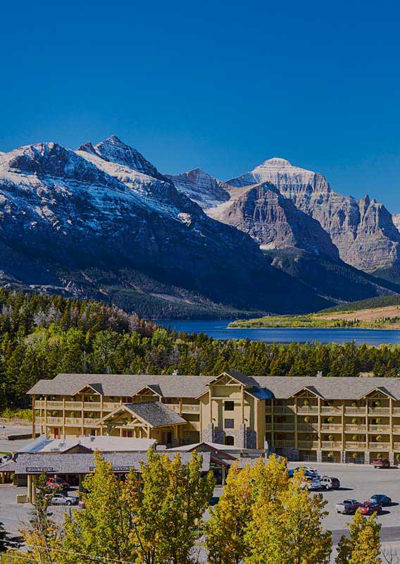 St. Mary Village Lodge with St. Mary Lake and Glacier National Park in the background