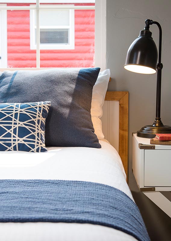 a bed and a lamp in a hotel room