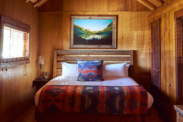 Master bedroom with one king bed in the Homestead House at St. Mary Village