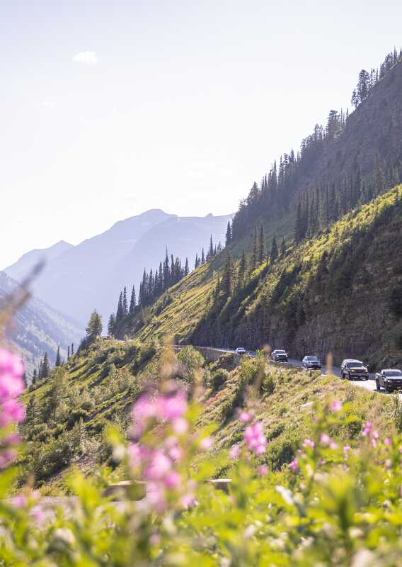Going to the Sun Road at sunset with light streaming over the mountains.