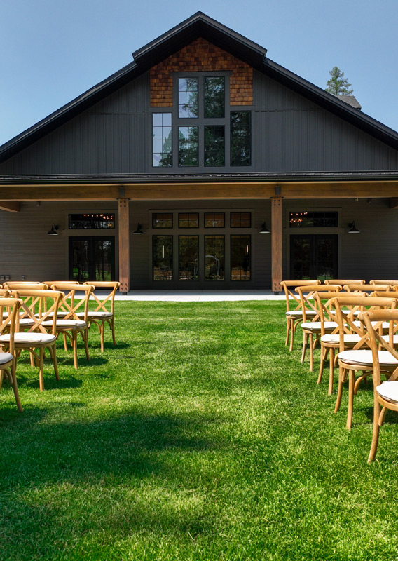 An exterior view of an event center with chairs set up outside.