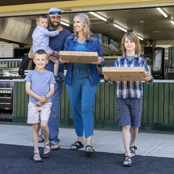 Family taking pizzas to go from Glacier National Pizza