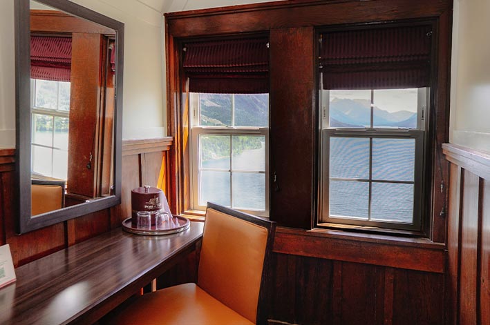 Windows overlooking a blue lake.