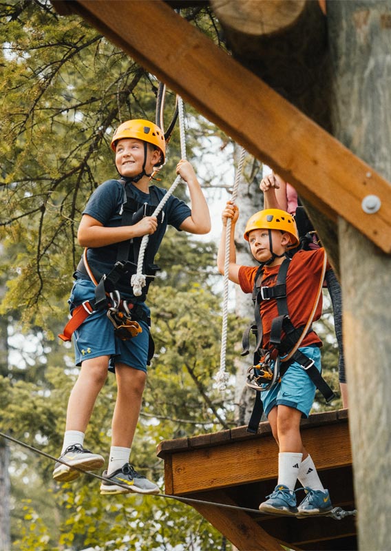 A person attached with a swing jumps from a platform.