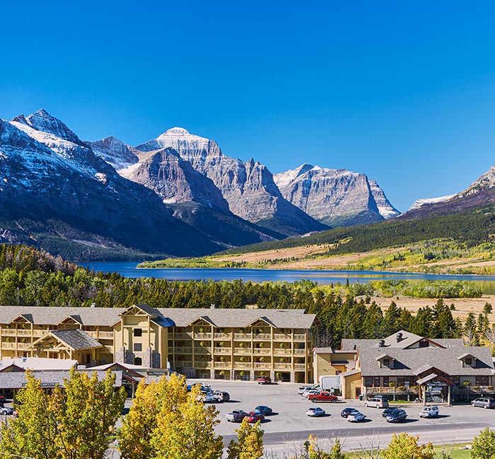 St. Mary Village from above, with a mountain range and river behind it.